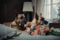two dogs laying on a bed with a bouquet of flowers