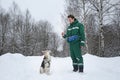 Two dogs walk outdoors in winter with an owner Royalty Free Stock Photo