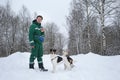 Two dogs walk outdoors in winter with an owner Royalty Free Stock Photo