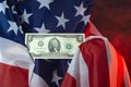 Two dollar bill of the united states of america held by the american flag against the background of red smoke, concept symbol Royalty Free Stock Photo