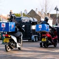 Two Domino Pizza Home Delivery Drivers Riding Scooters