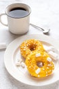 Two donuts with marshmallows and a cup of tea or coffee Royalty Free Stock Photo