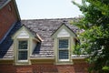 Two Dormers on Brick Homes with Wood Shingles