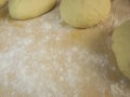 Two dough and flour on a wooden board