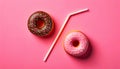 Two doughnuts and a straw on a pink background, AI-generated. Royalty Free Stock Photo