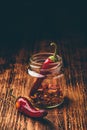 Two dried red chili peppers in jar Royalty Free Stock Photo