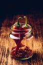 Two dried red chili peppers in jar Royalty Free Stock Photo