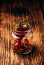 Two dried red chili peppers in jar Royalty Free Stock Photo