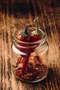 Two dried red chili peppers in jar Royalty Free Stock Photo