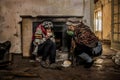 Two drifters eating bread at abandoned house