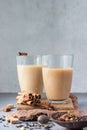 Two drinking glasses with traditional Indian drink - masala chai tea milk tea with spices for making tea. Royalty Free Stock Photo