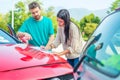 Woman and man friendly reporting the damage of the car after accident Royalty Free Stock Photo