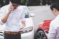 Two drivers man arguing after a car traffic accident collision and making phone call to Insurance Agent, Traffic Accident and Royalty Free Stock Photo