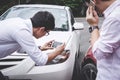 Two drivers man arguing after a car traffic accident collision and making phone call to Insurance Agent and take a photo, Traffic Royalty Free Stock Photo