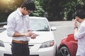 Two drivers man arguing after a car traffic accident collision a Royalty Free Stock Photo