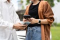 Two Drivers using a smartphone to exchange phone numbers and social media after a car accident. Concept of claim insurance for a Royalty Free Stock Photo