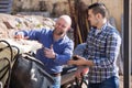 Two drivers working with tractor