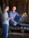 Two drivers working with tractor