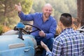 Two drivers working with tractor