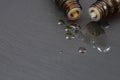 two dropper bottles with essential oil spilling and mixing oil drops Royalty Free Stock Photo
