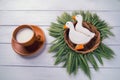 Two duck shaped ginger cookies with basket nest wreath with spikelets top view with tea cup on a white wooden background. Royalty Free Stock Photo