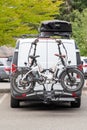 Two E-Bikes on Bicycle Rack on Back of Van Royalty Free Stock Photo