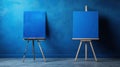 Two easels with blue canvases in front of a wall, AI Royalty Free Stock Photo