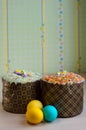 Two Easter cakes and three colored eggs, yellow and blue Royalty Free Stock Photo
