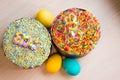 Two Easter cakes and three colored eggs, yellow and blue Royalty Free Stock Photo