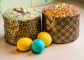 Two Easter cakes and three colored eggs, yellow and blue Royalty Free Stock Photo