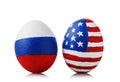 Two Easter eggs painted in colors of the flags of Russia and America on white background Royalty Free Stock Photo