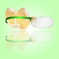 Two Easter golden eggs tied a green ribbon with a tag on a light green background. Royalty Free Stock Photo