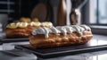 Two eclairs with chocolate icing on the table close-up. Royalty Free Stock Photo
