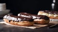 Two eclairs with chocolate icing on the table close-up. Royalty Free Stock Photo