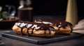 Two eclairs with chocolate icing and white chocolate on the table close-up. Royalty Free Stock Photo