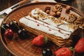 Two eclairs decorated with berries and nuts Royalty Free Stock Photo