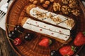 Two eclairs decorated with berries and nuts Royalty Free Stock Photo