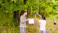 Two ecologist getting samples of foliage in city park Royalty Free Stock Photo