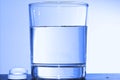 Two effervescent tablets and glass with water