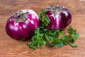 Two eggplants Helios and parsley on the wooden rustic table Royalty Free Stock Photo