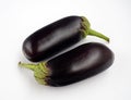 Two eggplants are parallel to each other. Vegetables isolated on a white background. Royalty Free Stock Photo