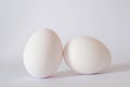 Close up view of white raw chicken eggs isolated on white background with soft shadow, selective focus. Royalty Free Stock Photo