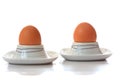 Two eggs in eggcups reflecting Royalty Free Stock Photo