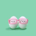 Two eggs in pink glasses like Siamese twins