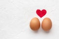 Two eggs with red heart on white background with egg`s shadow Valentines day concept Royalty Free Stock Photo