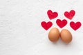 Two eggs with red hearts on white background with egg`s shadow Valentines day concept Royalty Free Stock Photo