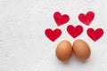 Two eggs with red hearts on white background with egg`s shadow Valentines day concept Royalty Free Stock Photo
