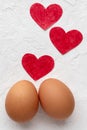 Two eggs with red hearts on white background with Valentines day concept Royalty Free Stock Photo