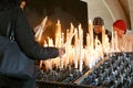 Two elder and one middle age prayers firing candles in church Royalty Free Stock Photo