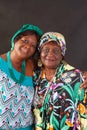 Two elderly African American sisters wearing colorful turbans